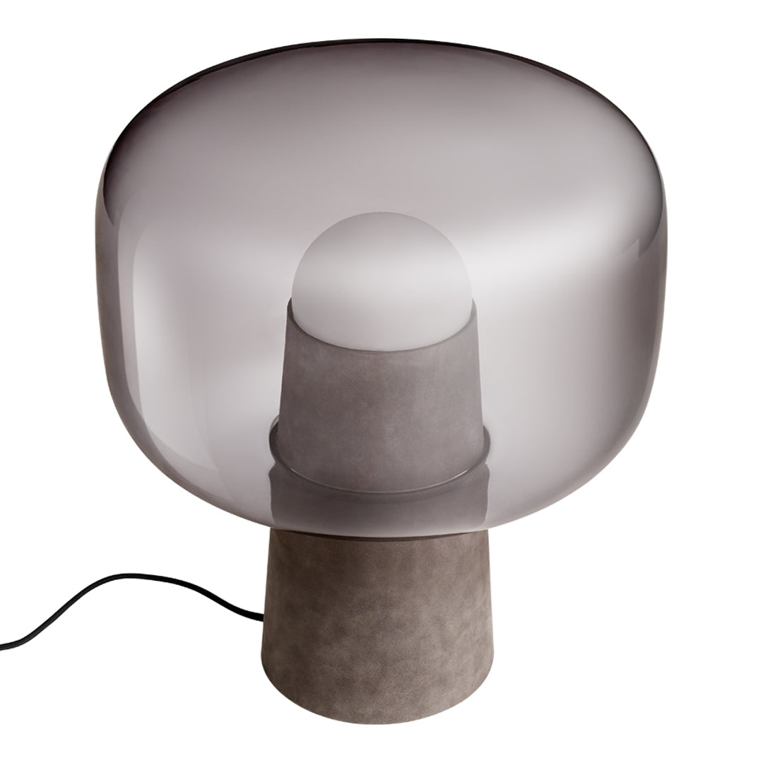Smoky gray glass lamp with a rounded shape and a concrete base, showcasing modern minimalism and elegant simplicity.