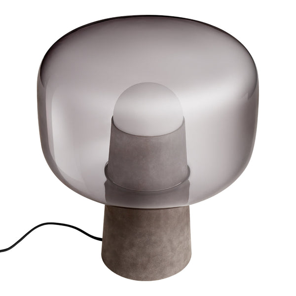 Smoky gray glass lamp with a rounded shape and a concrete base, showcasing modern minimalism and elegant simplicity.