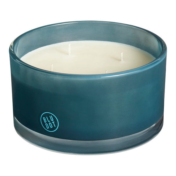 Teal glass candle holder with a smooth gradient finish and three white wicks. Simple, modern design.