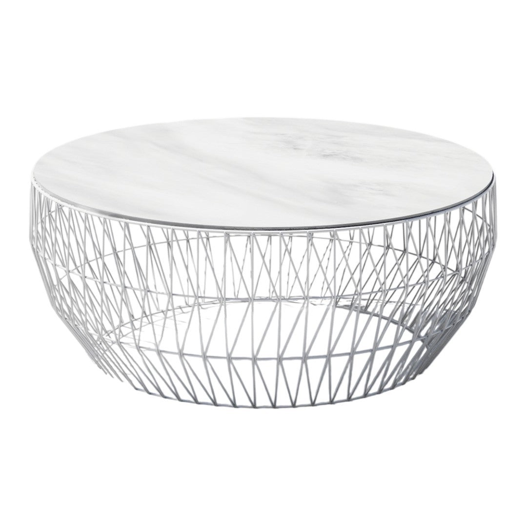 Round coffee table with a white marble top and a geometric wireframe base in silver. Modern and elegant design.