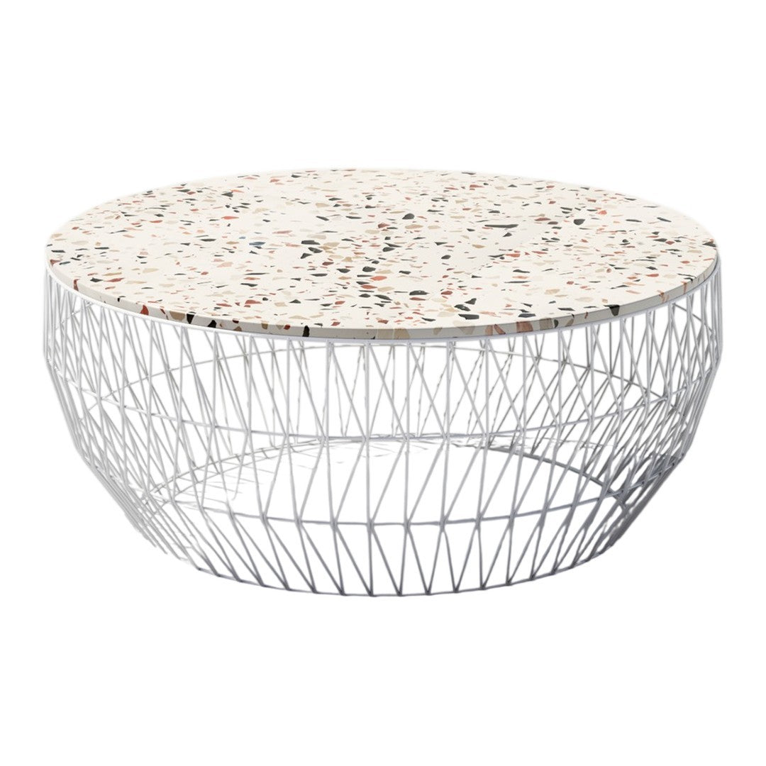 Round coffee table with a speckled white terrazzo top and a geometric silver wire base. Perfect for modern decor.