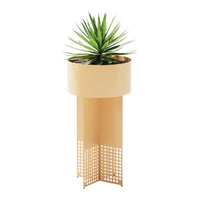 Yellow metal planter with a geometric cut-out pattern, holding a vibrant green plant.