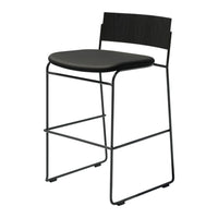 Black metal bar stool with a sleek design and smooth black seat, featuring minimalist lines and modern patterns.