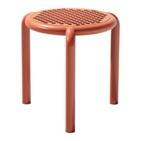 Terracotta round stool with perforated pattern and smooth, rounded legs, perfect for a modern decor.