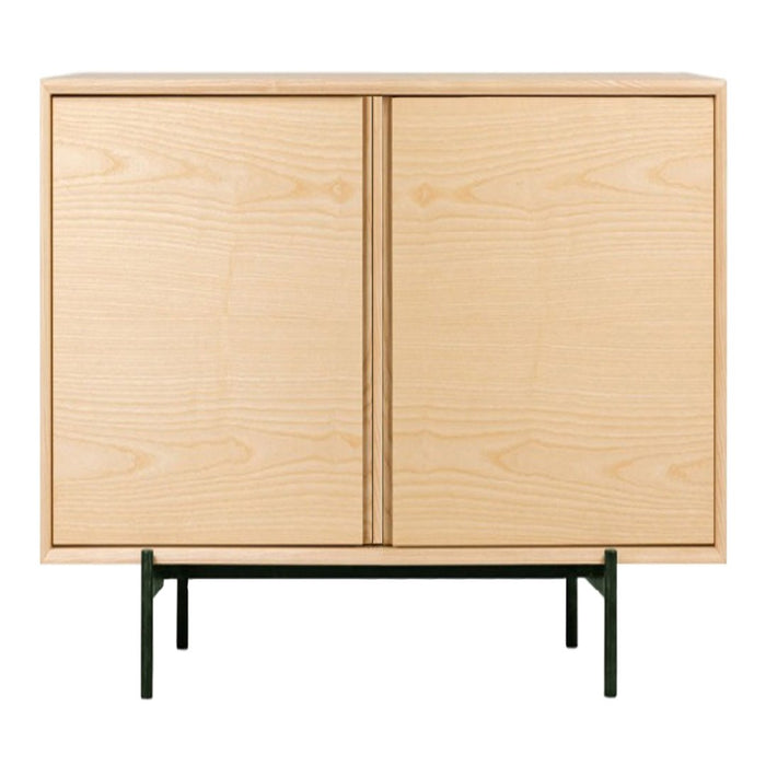 Light natural wood cabinet with a smooth finish and minimalist design, featuring a green metal base.