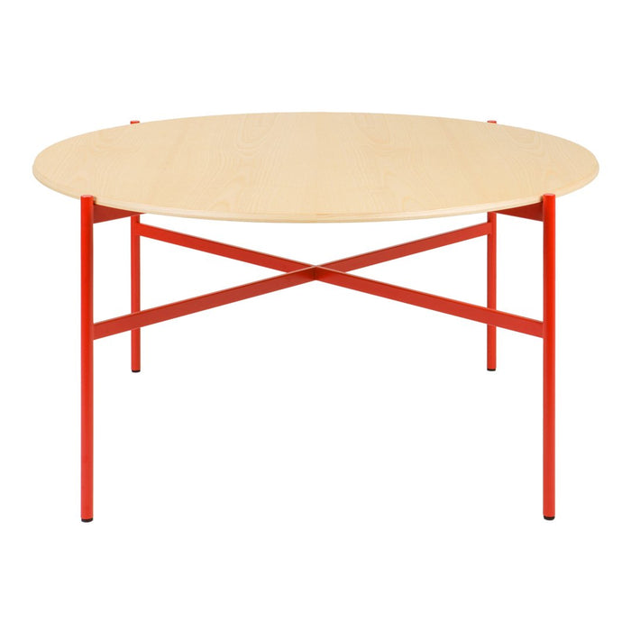 Round wooden table with a natural finish and bold red metal legs in an X-base design. Modern and vibrant look.