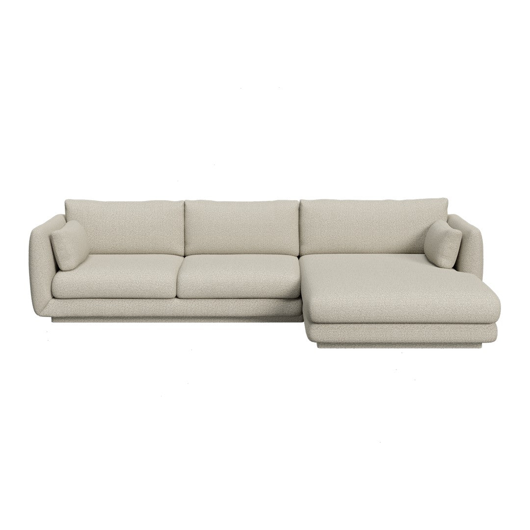 Light beige sofa with smooth fabric and minimalist design, featuring plush cushions and a cozy chaise lounge.