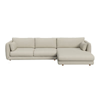 Light beige sectional sofa with smooth fabric and minimalist design, featuring soft cushions and tapered wooden legs.