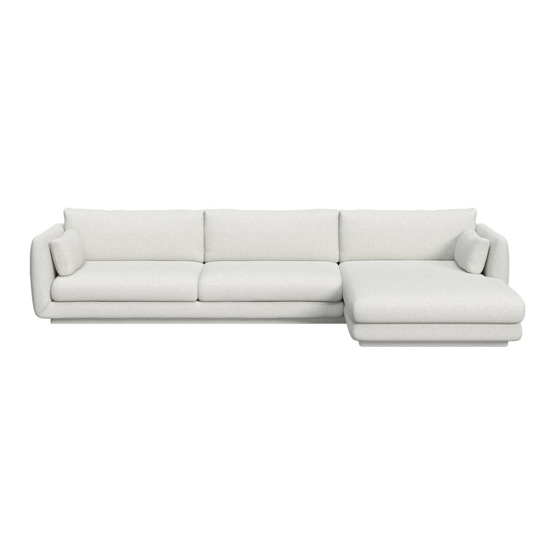 White sectional sofa with a smooth, minimalist design and plush, comfortable cushions. Ideal for modern interiors.