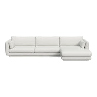 White sectional sofa with a smooth, minimalist design and plush, comfortable cushions. Ideal for modern interiors.