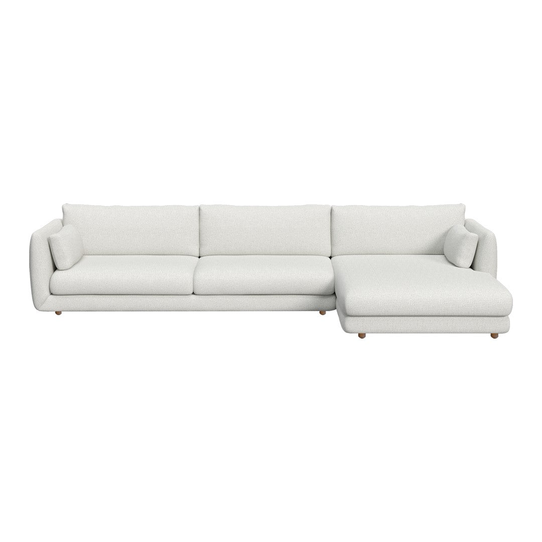 Modern white sectional sofa with sleek lines and plush cushions, featuring solid pale tones and smooth textures.