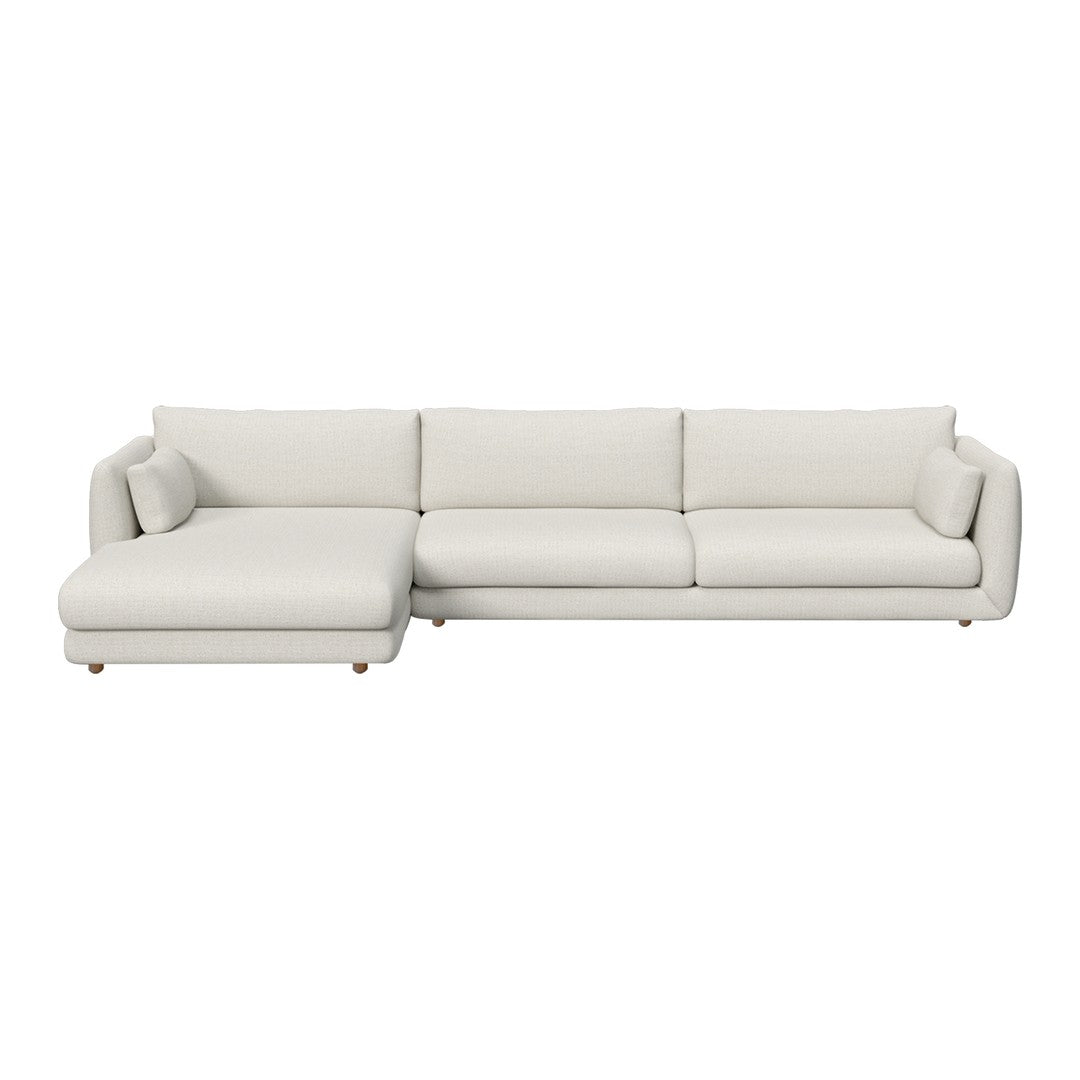 Neutral beige sectional sofa with smooth upholstery and minimalist design, featuring a matching chaise lounge.