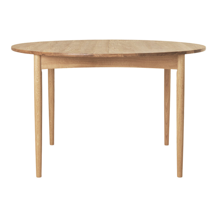 Light wood round dining table with a smooth finish and natural grain pattern, featuring slender legs for a modern look.