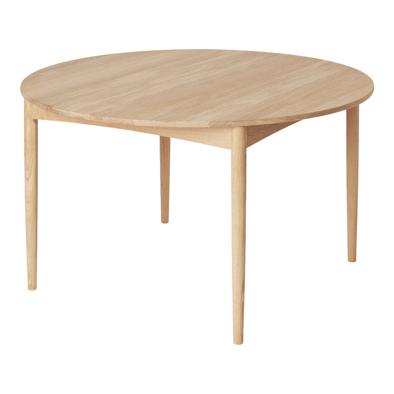Lightwood round dining table with a smooth, natural finish and minimalistic design. Ideal for modern settings.