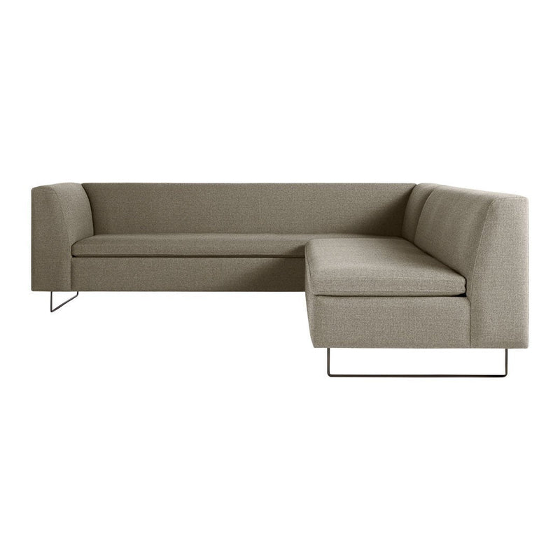 Modern L-shaped sofa in a soft taupe fabric with a sleek, minimalist design and stainless steel legs.