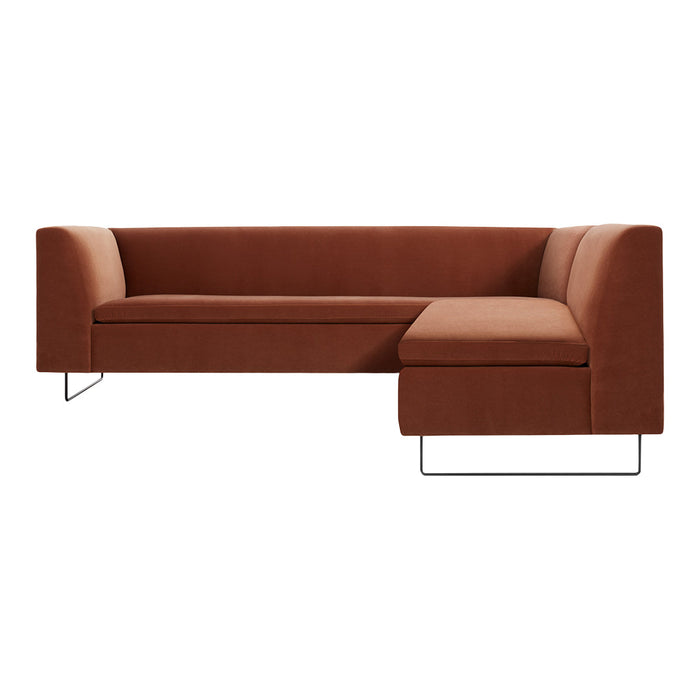 Rust orange sectional sofa with a smooth, minimalist design and metal legs. Stylish and versatile for modern decor.