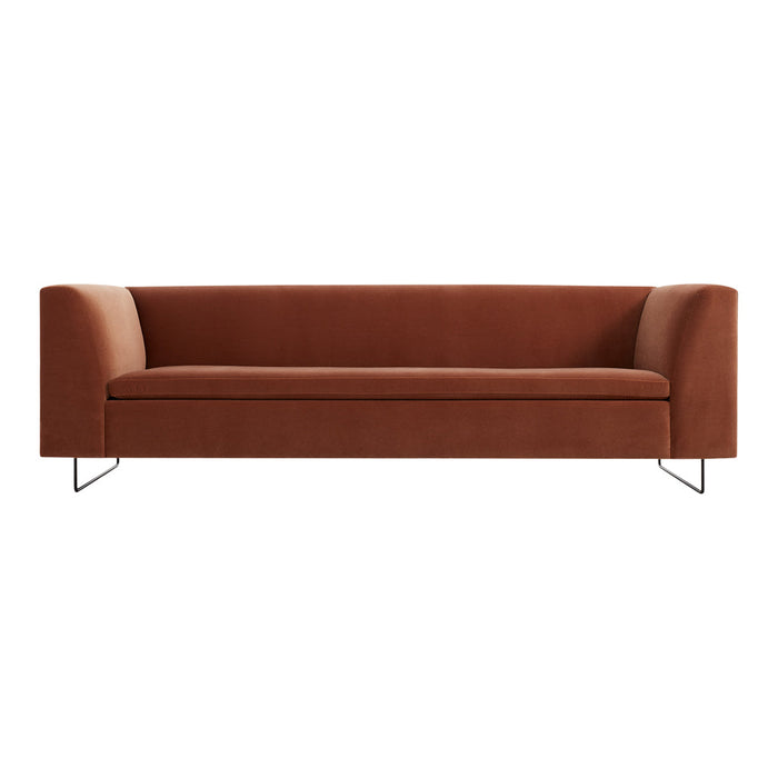 Rust-colored modern sofa with smooth upholstery and sleek metal legs, featuring a minimalist design.