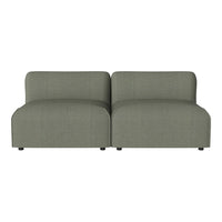 Green modern sofa with a minimalist design and soft, textured upholstery, perfect for contemporary living spaces.