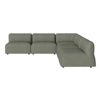 "Modern sectional sofa in soft sage green fabric with minimalist design and smooth, curved lines."