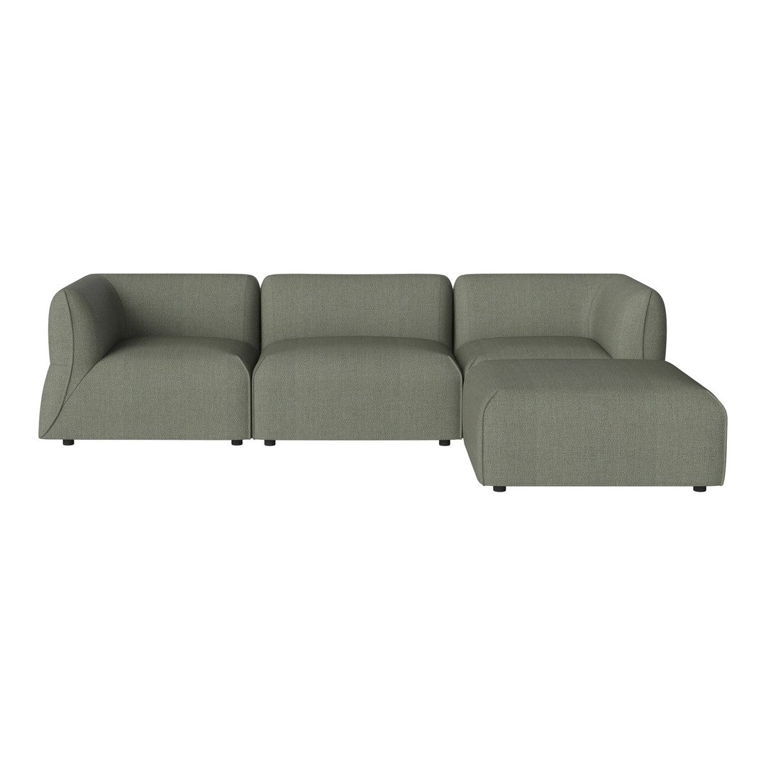 Contemporary sectional sofa in soft green upholstery with a smooth texture and minimalist design.