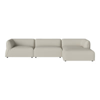 Modern sectional sofa in soft beige fabric, featuring smooth lines and a minimalist design with no visible patterns.