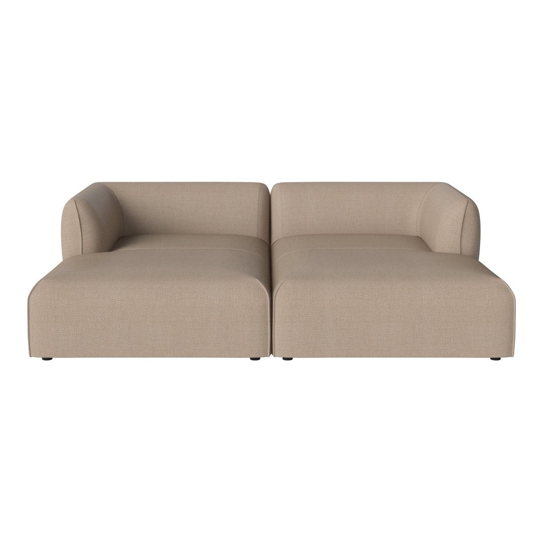 Beige modular sofa with a smooth texture and minimalist design, featuring clean lines and a contemporary look.