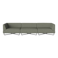 Modern sectional sofa in muted olive green fabric with sleek black metal base and minimalist design.