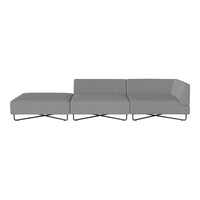 Modern gray sectional sofa with sleek lines and minimalistic design, featuring a solid color fabric and cross legs.