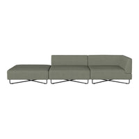 Modern sectional sofa in muted green fabric with clean lines and minimalist design, featuring a sleek metal base.