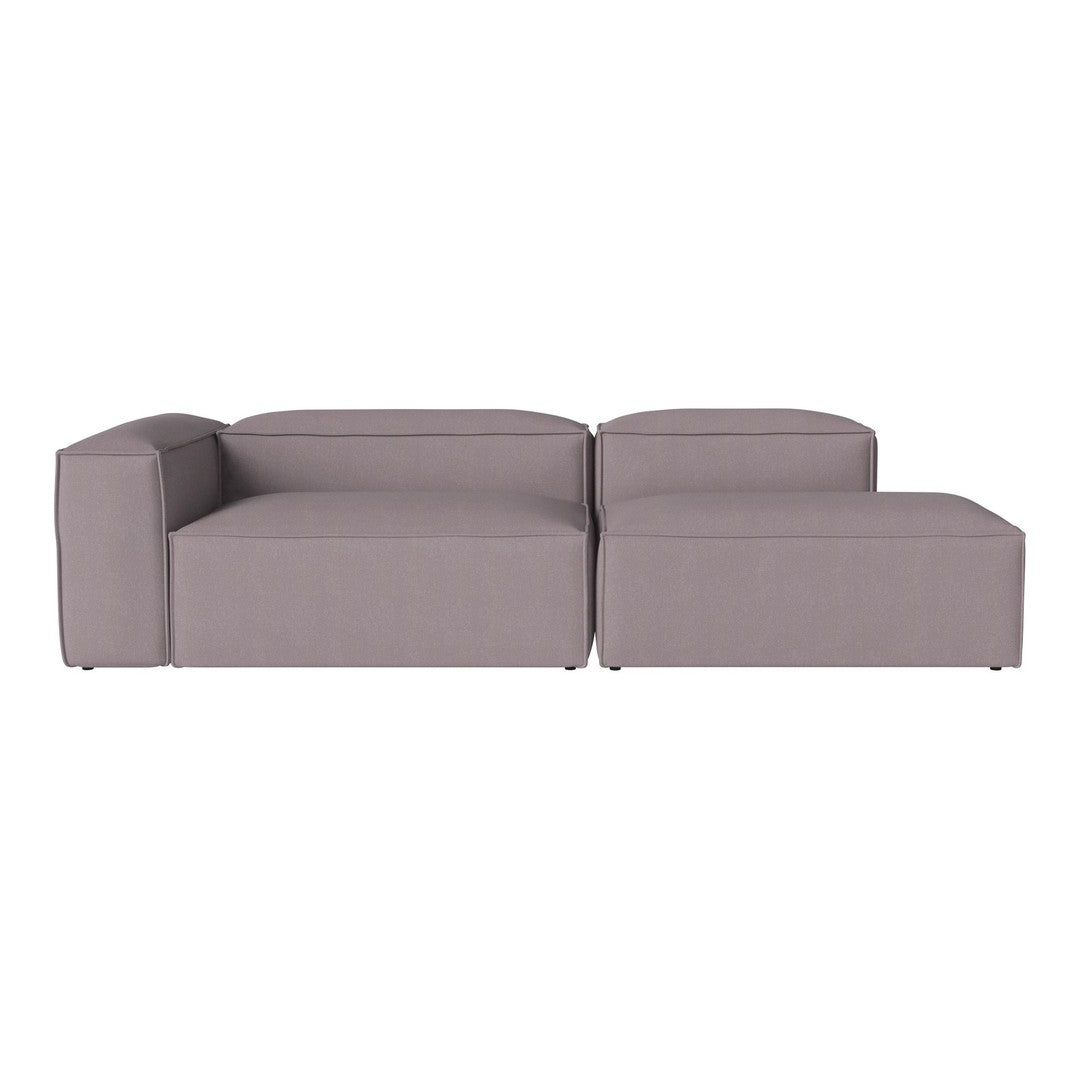 Modern sectional sofa in soft gray fabric with a minimalistic, tufted design and clean lines for contemporary decor.