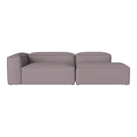 Modern sectional sofa in soft gray fabric with a minimalistic, tufted design and clean lines for contemporary decor.