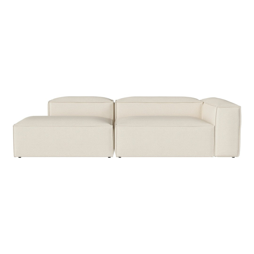 Cream-colored modular sofa with a smooth, minimalist design and subtle textured fabric.