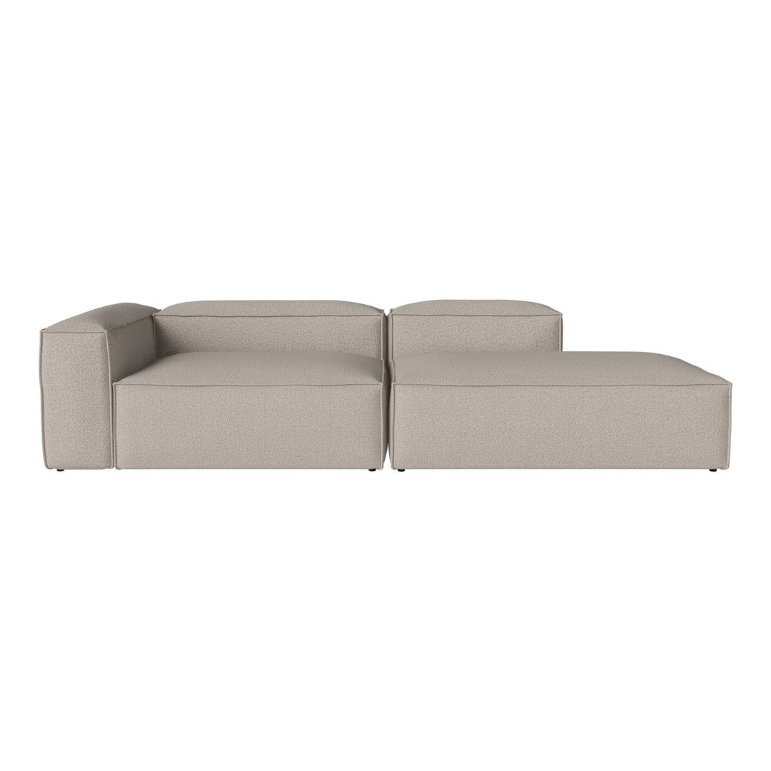 Beige modular sofa with a minimalist design, featuring clean lines and a smooth, textured fabric.