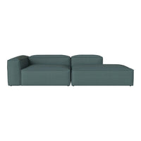 Teal sectional sofa with a modern, minimalist design and clean lines, featuring a solid, textured fabric.