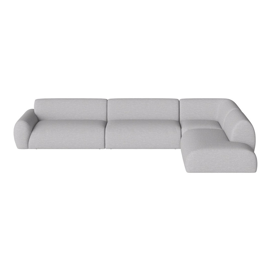 Light grey sectional sofa with smooth, minimalist design and soft, textured fabric for modern decor.