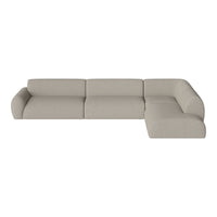Modern sectional sofa in soft beige fabric with a smooth, minimalist design and subtle textural pattern.