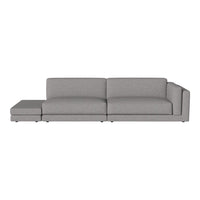 Gray sectional sofa with a minimalist design and clean lines, featuring a sleek, solid color upholstery.