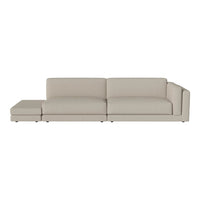 Beige sectional sofa with sleek, modern lines and a minimalist design for contemporary living spaces.