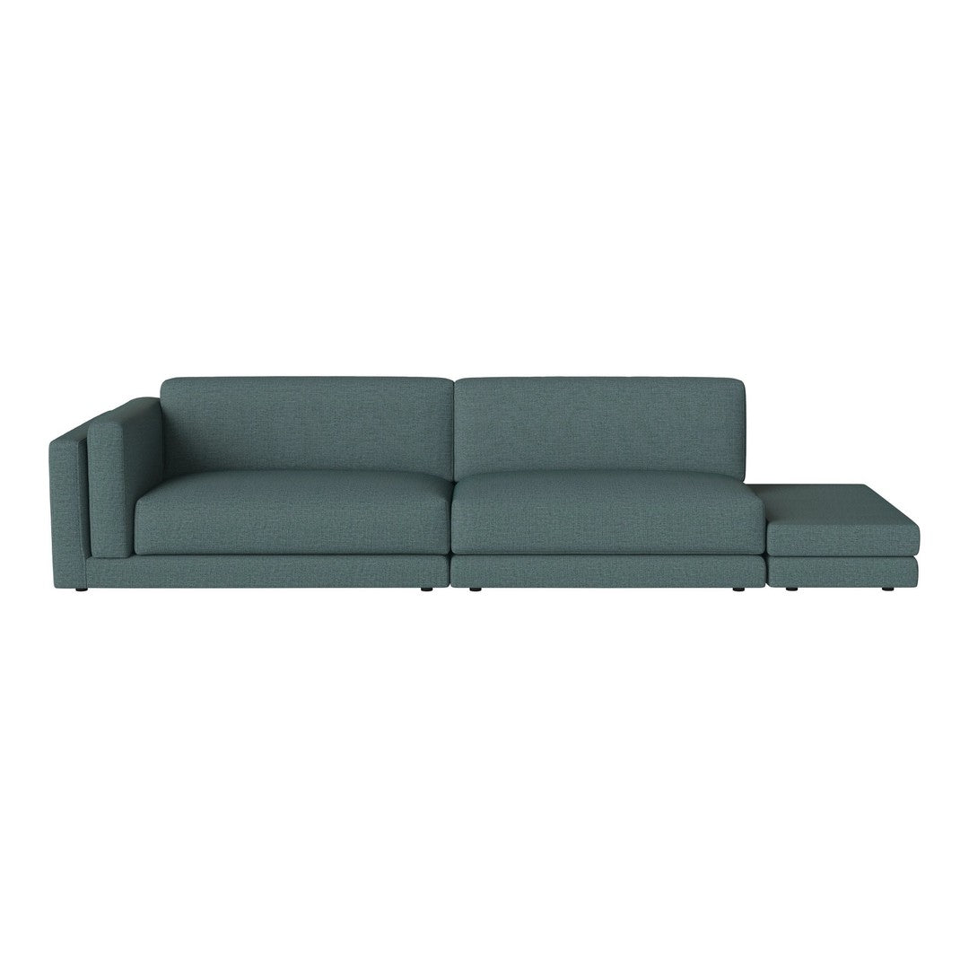 Teal sectional sofa with a sleek modern design, featuring soft fabric upholstery and clean lines.
