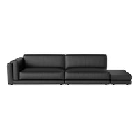 Sleek black leather sectional sofa with minimalist design and smooth texture, perfect for modern living spaces.