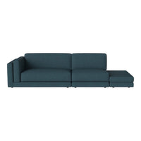 Teal sectional sofa with a modern design and clean lines, featuring a solid color and no visible patterns.