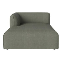 Sleek green chaise lounge with a minimalist design and subtle textured fabric. Perfect for modern decor.