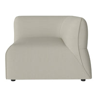 Minimalist beige sectional chair featuring smooth curves and a subtle texture. Perfect for modern interiors.