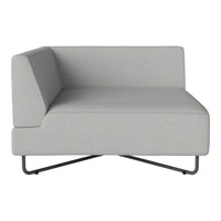 Modern gray chaise lounge with clean lines and a minimalist design, featuring a textured fabric surface.