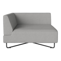 Gray fabric corner chair with a minimalist design and clean lines, featuring a modern metal base.