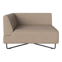 Beige upholstered corner sofa with a minimalist design and subtle texture, featuring a sleek black metal base.