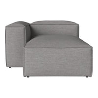 Gray modular lounge chair with a smooth, textured fabric and modern geometric shape. Ideal for contemporary decor.