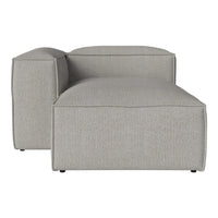 Light grey modular chaise lounge with a smooth, textured fabric finish. Modern, minimalist design.