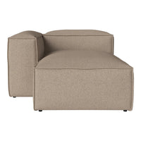 Tan upholstered sectional sofa with a minimalist design and subtle texture, perfect for modern interiors.