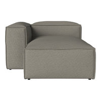 Modern chaise lounge in a textured gray fabric, featuring clean lines and a minimalist design for contemporary interiors.